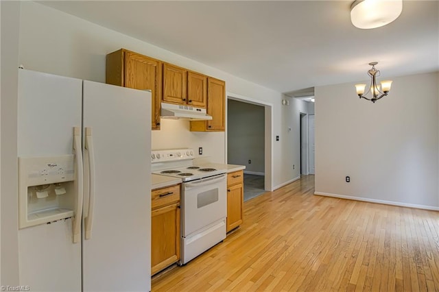 5201 Harvey Rd, Jamestown, NC 27282 - kitchen featuring white appliances, under cabinet range hood, light wood finished floors, and a chandelier