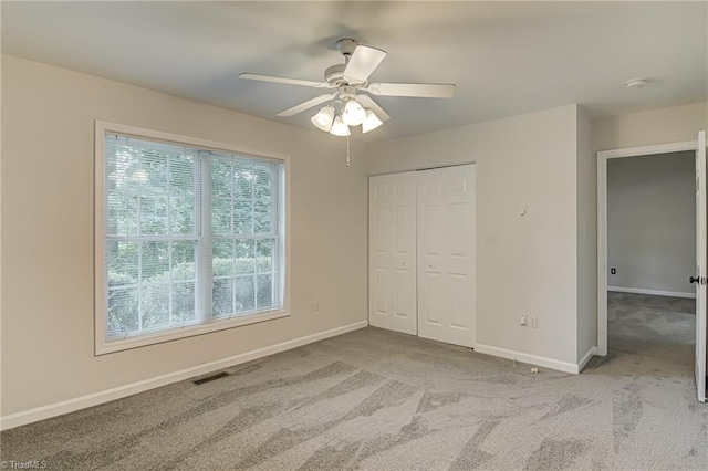 5201 Harvey Rd, Jamestown, NC 27282 - unfurnished bedroom featuring carpet, a closet, and a ceiling fan