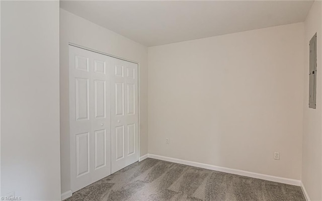 5201 Harvey Rd, Jamestown, NC 27282 - unfurnished bedroom featuring dark colored carpet, a closet, and electric panel