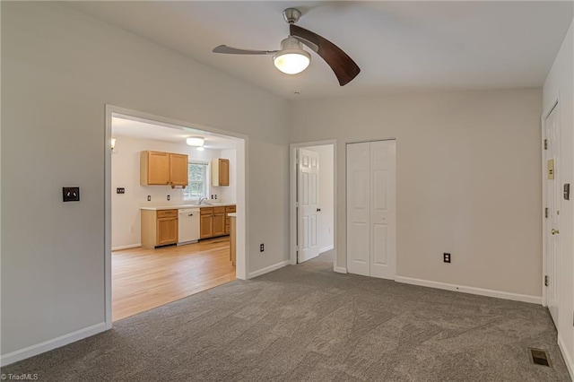 5201 Harvey Rd, Jamestown, NC 27282 - unfurnished living room featuring light colored carpet and a ceiling fan