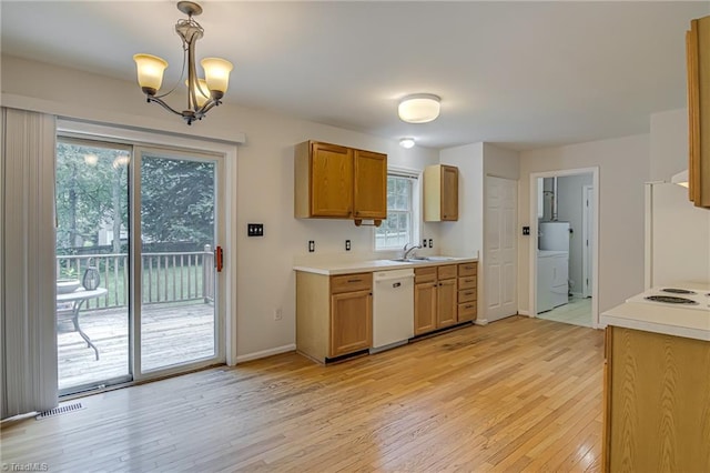 5201 Harvey Rd, Jamestown, NC 27282 - kitchen featuring white appliances, washer / clothes dryer, light wood-type flooring, a chandelier, and light countertops