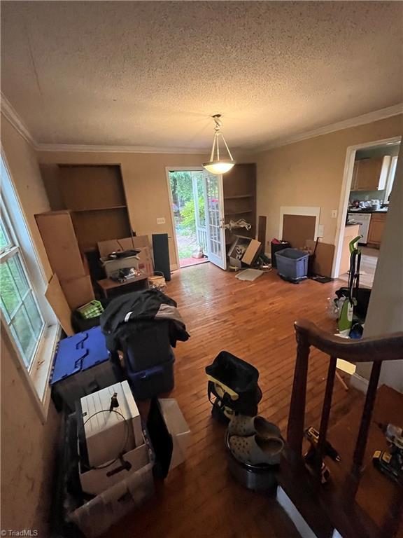3603 Castleton Rd, Greensboro, NC 27406 - living area with wood finished floors, a textured ceiling, and crown molding