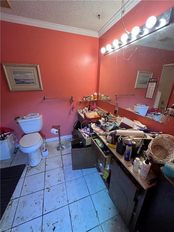 3603 Castleton Rd, Greensboro, NC 27406 - bathroom with crown molding, toilet, double vanity, a textured ceiling, and tile patterned flooring