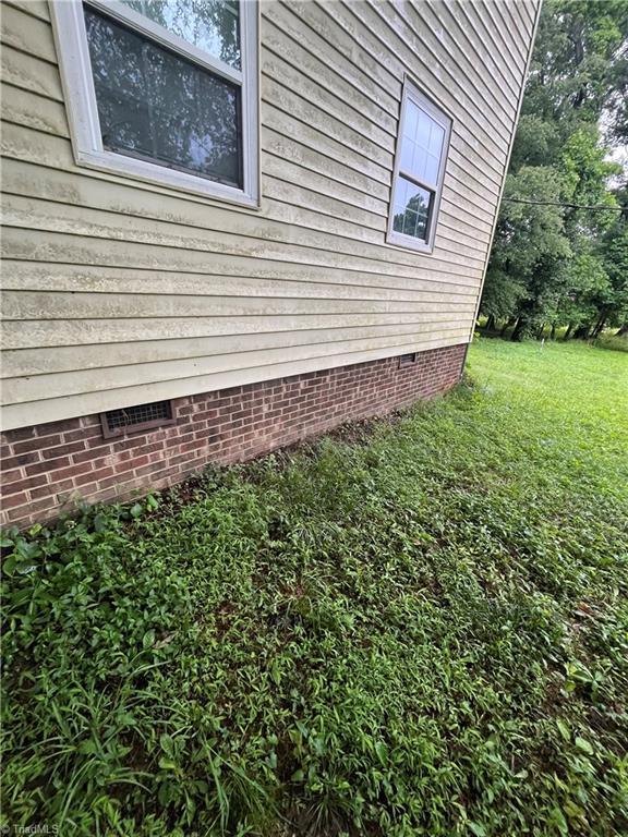 3603 Castleton Rd, Greensboro, NC 27406 - view of home's exterior featuring crawl space and a yard