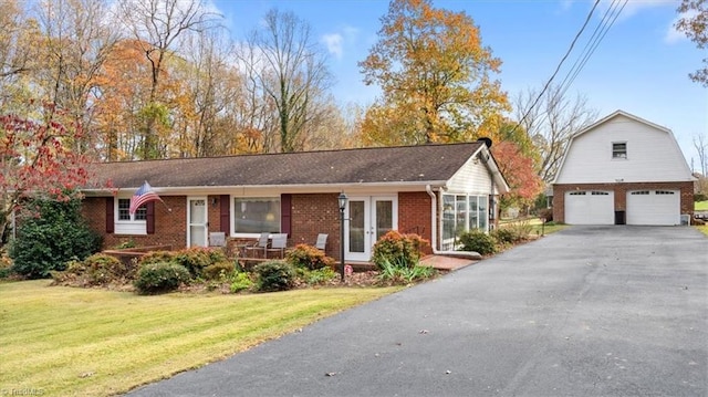 ranch-style house with an outbuilding, a front lawn, and a garage