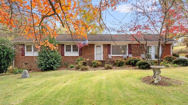 ranch-style home with french doors and a front yard