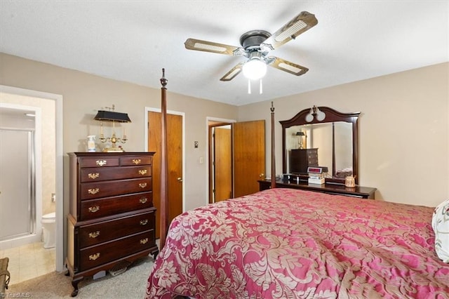 carpeted bedroom with ceiling fan and ensuite bathroom