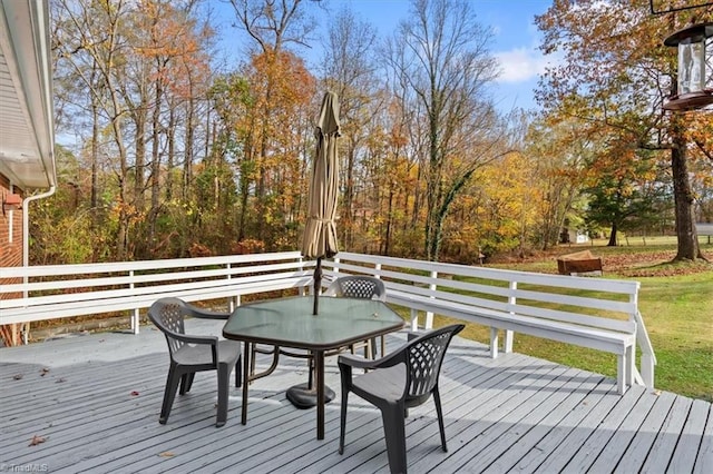 wooden terrace featuring a lawn