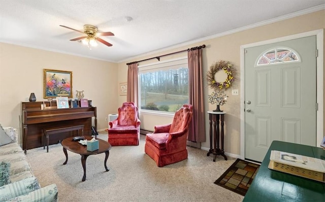 sitting room with carpet, a baseboard radiator, ceiling fan, and ornamental molding