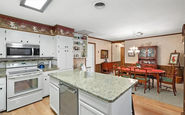 kitchen with a center island, hanging light fixtures, light wood-type flooring, white cabinetry, and stainless steel appliances