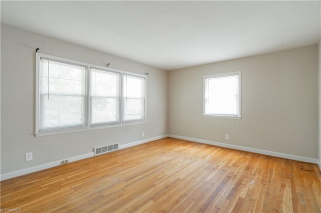 empty room with light hardwood / wood-style flooring