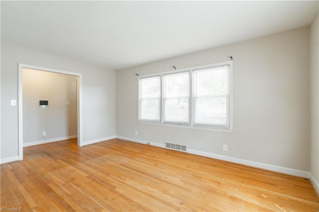 spare room featuring light wood-type flooring