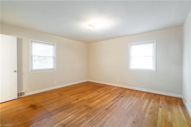 spare room with light hardwood / wood-style flooring