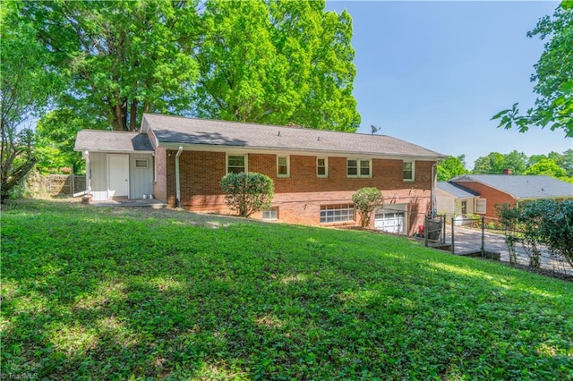 view of front of property with a garage and a front lawn