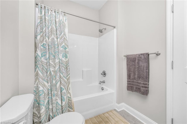 bathroom featuring toilet and shower / bath combo