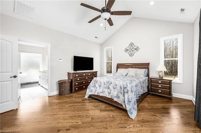 bedroom with lofted ceiling, dark hardwood / wood-style floors, connected bathroom, and ceiling fan