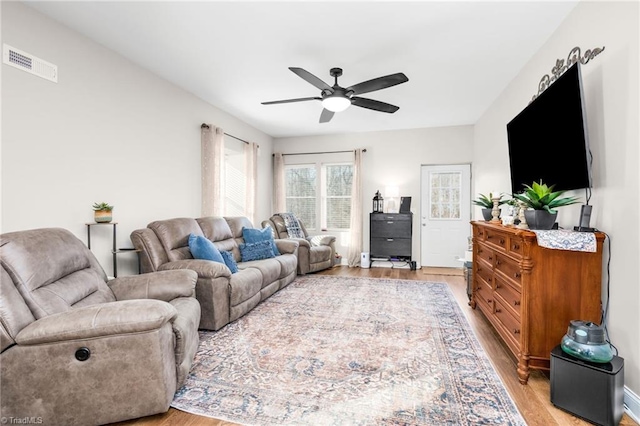 living room featuring ceiling fan and light wood-type flooring