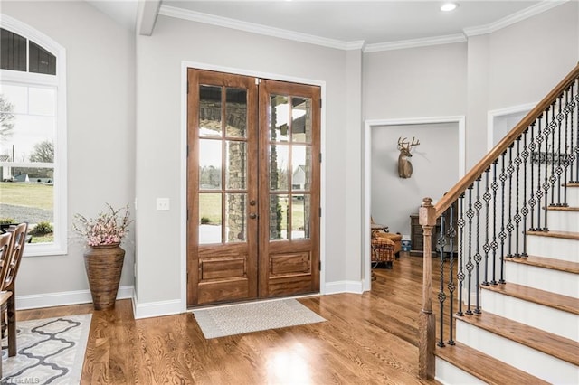 entryway featuring crown molding, hardwood / wood-style flooring, and french doors