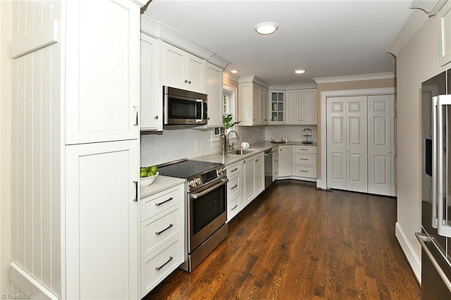 2700 Regency Dr, Winston-Salem, NC 27106 - kitchen with appliances with stainless steel finishes, light countertops, backsplash, glass insert cabinets, and recessed lighting