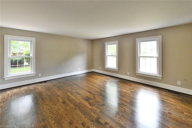 2700 Regency Dr, Winston-Salem, NC 27106 - unfurnished room with healthy amount of natural light, dark wood-type flooring, and baseboards