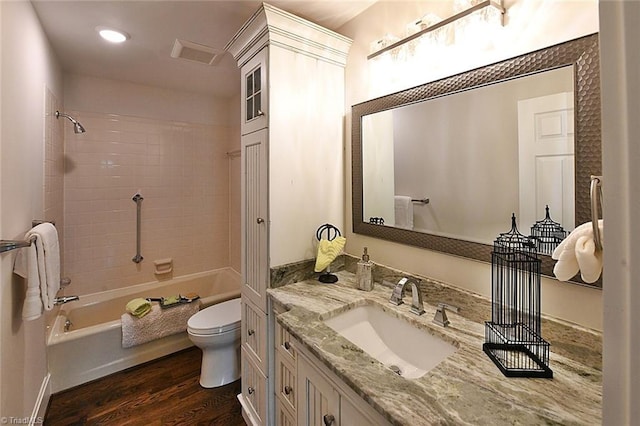 2700 Regency Dr, Winston-Salem, NC 27106 - bathroom featuring toilet, vanity, wood finished floors, shower / tub combination, and recessed lighting