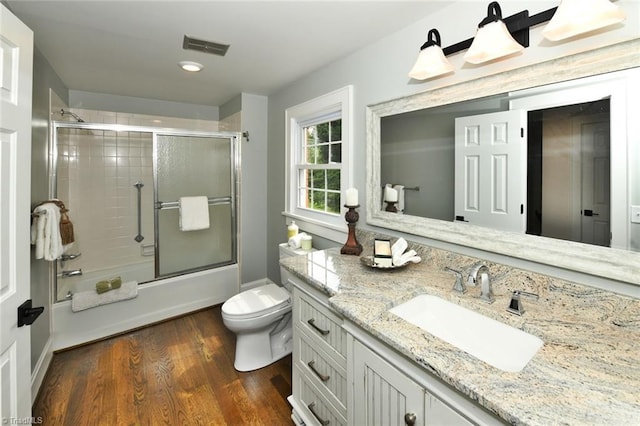 2700 Regency Dr, Winston-Salem, NC 27106 - full bathroom featuring vanity, toilet, combined bath / shower with glass door, and wood finished floors