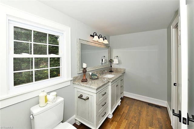 2700 Regency Dr, Winston-Salem, NC 27106 - bathroom with vanity, baseboards, toilet, and wood finished floors