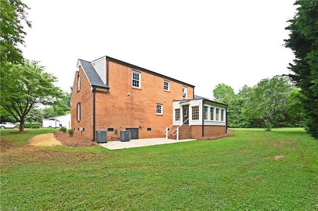2700 Regency Dr, Winston-Salem, NC 27106 - back of property with a patio area, a yard, brick siding, and entry steps