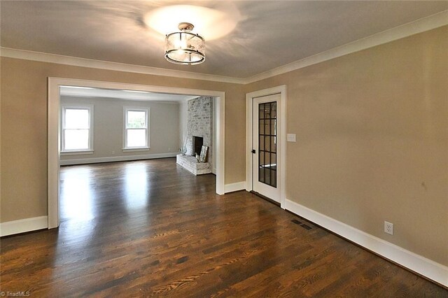 2700 Regency Dr, Winston-Salem, NC 27106 - unfurnished living room with crown molding, baseboards, a fireplace, and dark wood finished floors