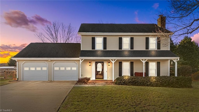 view of front of house with a lawn and a garage