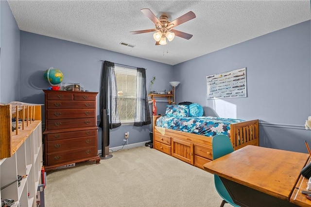 bedroom with carpet flooring, a textured ceiling, and ceiling fan