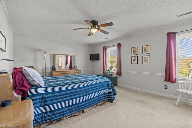 bedroom with ceiling fan, crown molding, a textured ceiling, and carpet flooring