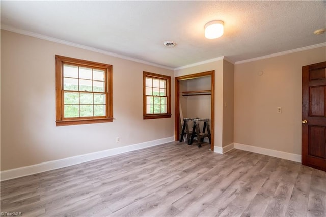 unfurnished bedroom with a closet, light hardwood / wood-style flooring, and ornamental molding