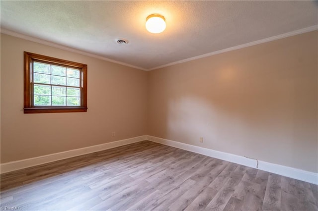 unfurnished room with a textured ceiling, crown molding, and light hardwood / wood-style flooring