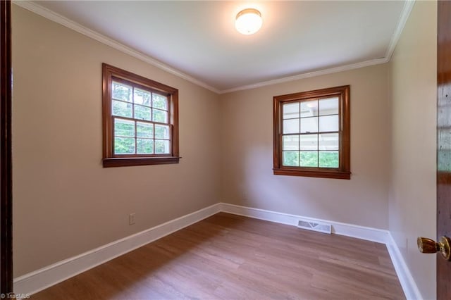 empty room with light wood-type flooring and ornamental molding