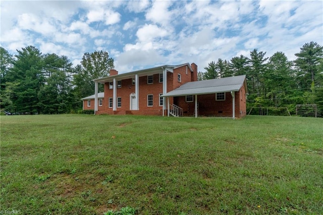 rear view of house featuring a yard