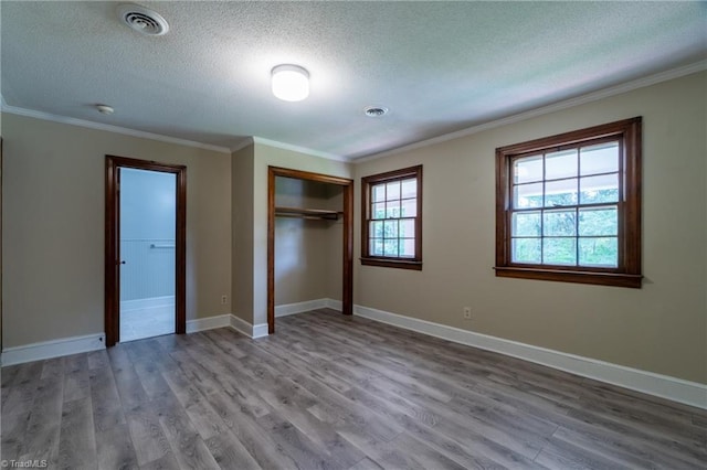 unfurnished bedroom featuring light hardwood / wood-style flooring and multiple windows