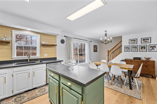 kitchen featuring decorative light fixtures, a notable chandelier, sink, green cabinets, and white cabinetry