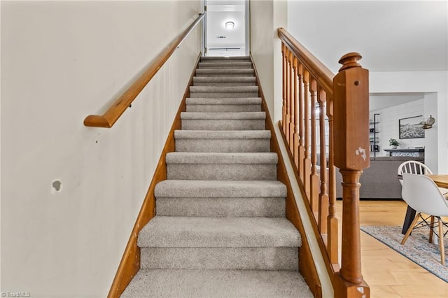 stairs featuring wood-type flooring