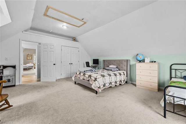 carpeted bedroom with vaulted ceiling and a closet