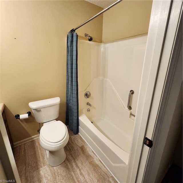 bathroom with toilet, shower / tub combo with curtain, and hardwood / wood-style floors