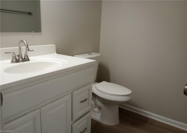 bathroom featuring hardwood / wood-style flooring, vanity, and toilet