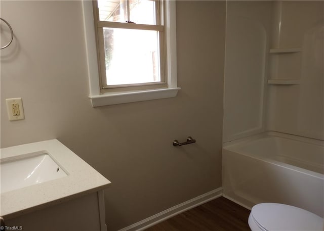 full bathroom featuring vanity, hardwood / wood-style floors, toilet, and bathtub / shower combination