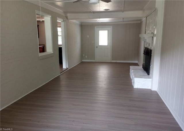 interior space featuring a fireplace, ceiling fan, and hardwood / wood-style flooring