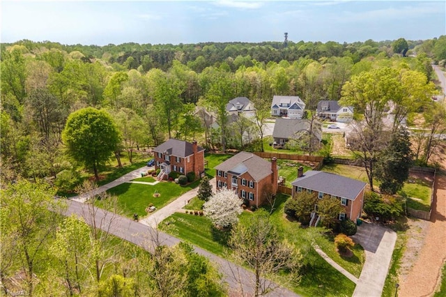 drone / aerial view with a residential view and a forest view