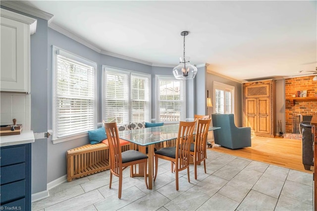 dining room with baseboards, a notable chandelier, light tile patterned floors, and crown molding