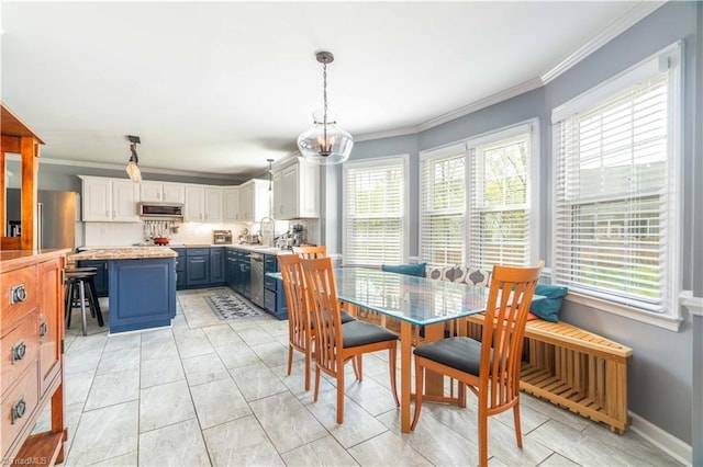 dining area with an inviting chandelier, ornamental molding, and plenty of natural light