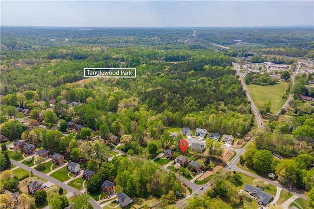 bird's eye view with a wooded view