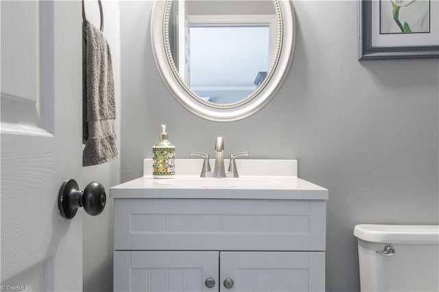 half bathroom with toilet and vanity