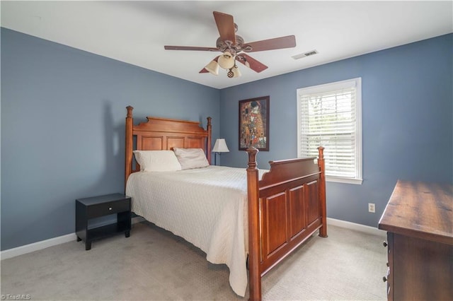 bedroom with baseboards, a ceiling fan, visible vents, and light colored carpet